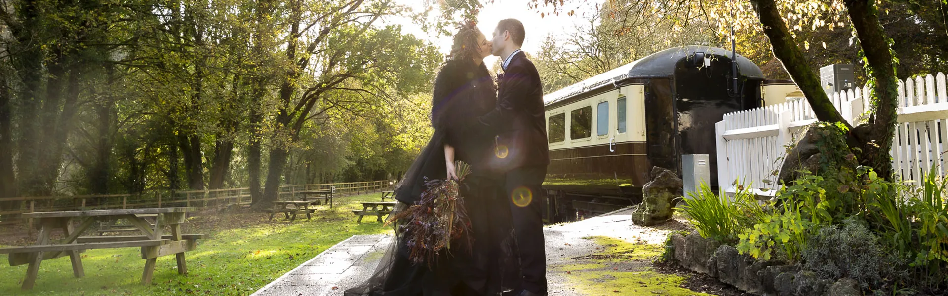 Gothic wedding photo of newly weds kissing at The Old Station in Tintern