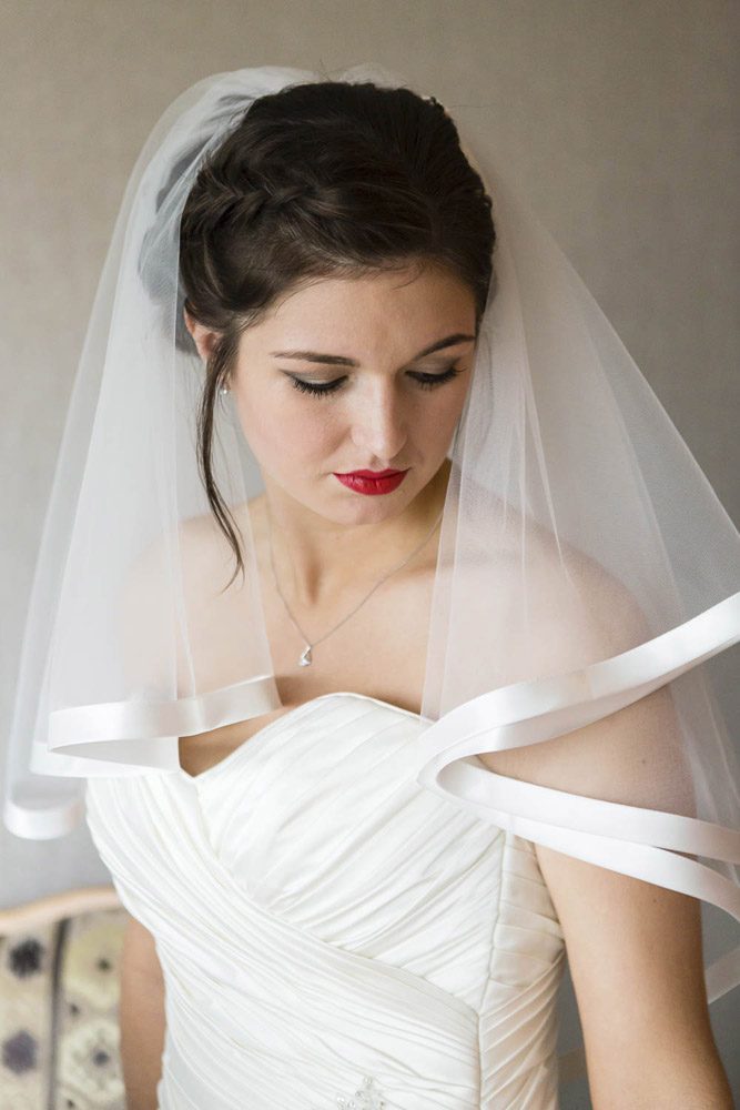 Lauren, the bride, radiates elegance in her superhero-themed wedding attire.